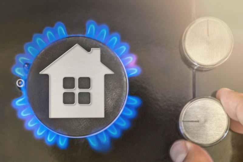 How Does My Gas Furnace Work? Photo of someone turning up a thermostat for a furnace.
