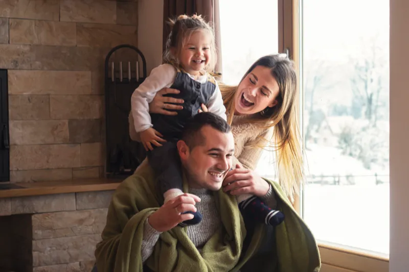 Why Air Conditioners Freeze Up. A family happily playing in their living room.